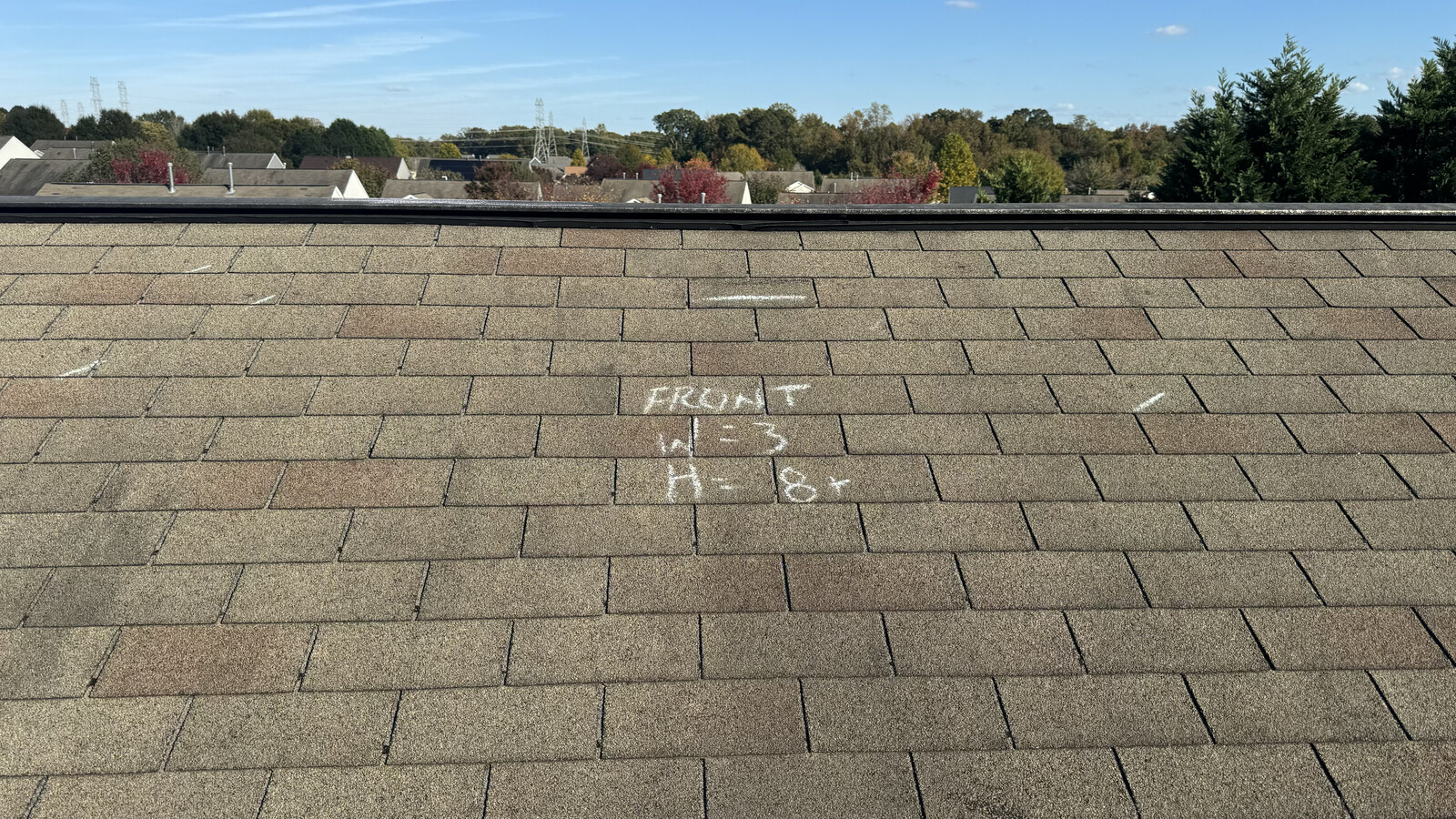 Hail damage inspection photo with chalk markings documenting wind and hail hits on a Charlotte-area roof &mdash; the kind of detailed documentation we provide insurance adjusters