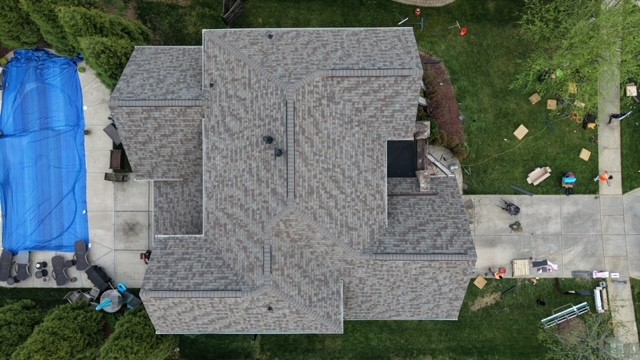 Aerial top-down view of a completed multi-gable architectural shingle roof replacement on a Fort Mill, SC home with pool