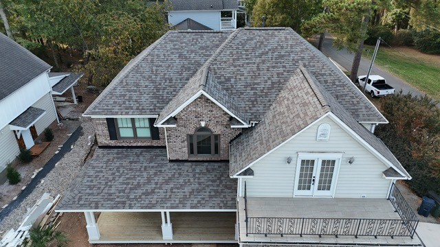 Completed two-story roof replacement on a brick-and-siding home in Huntersville, NC — architectural asphalt shingles by Charlotte Ace Roofing