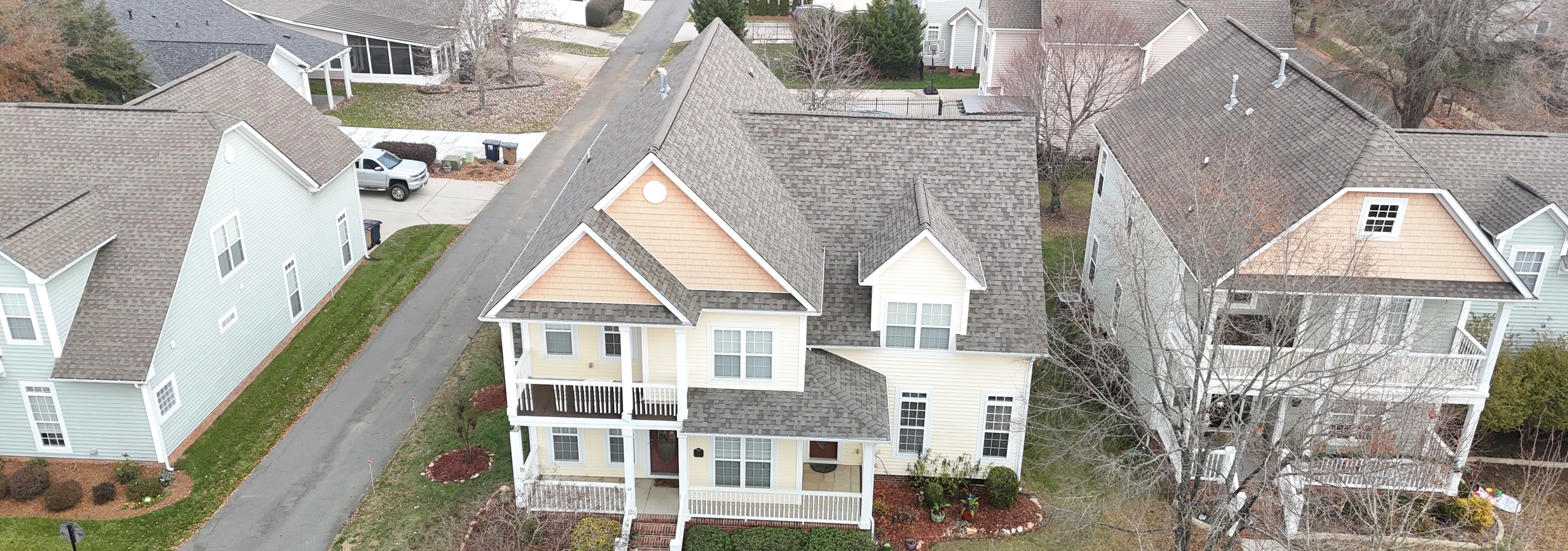Completed architectural shingle roof on a two-story home in an Indian Trail, NC subdivision — installed by Charlotte Ace Roofing