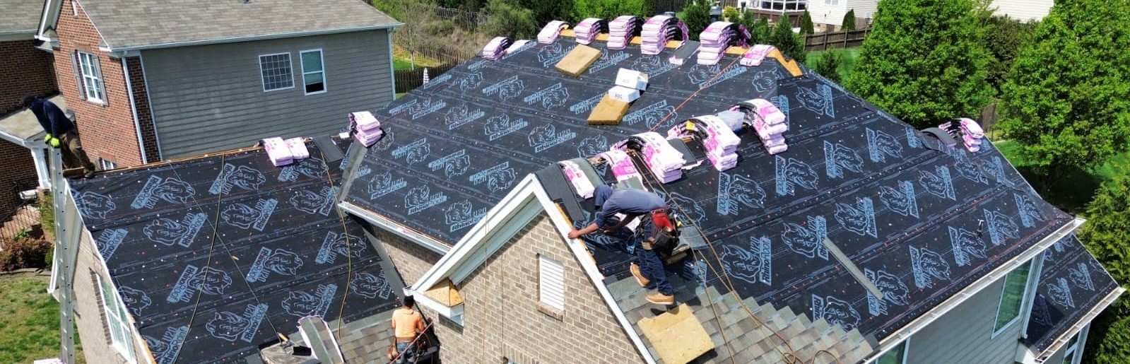 Aerial view of roof installation in progress in the Indian Trail, NC area — RhinoRoof underlayment with shingle bundles staged