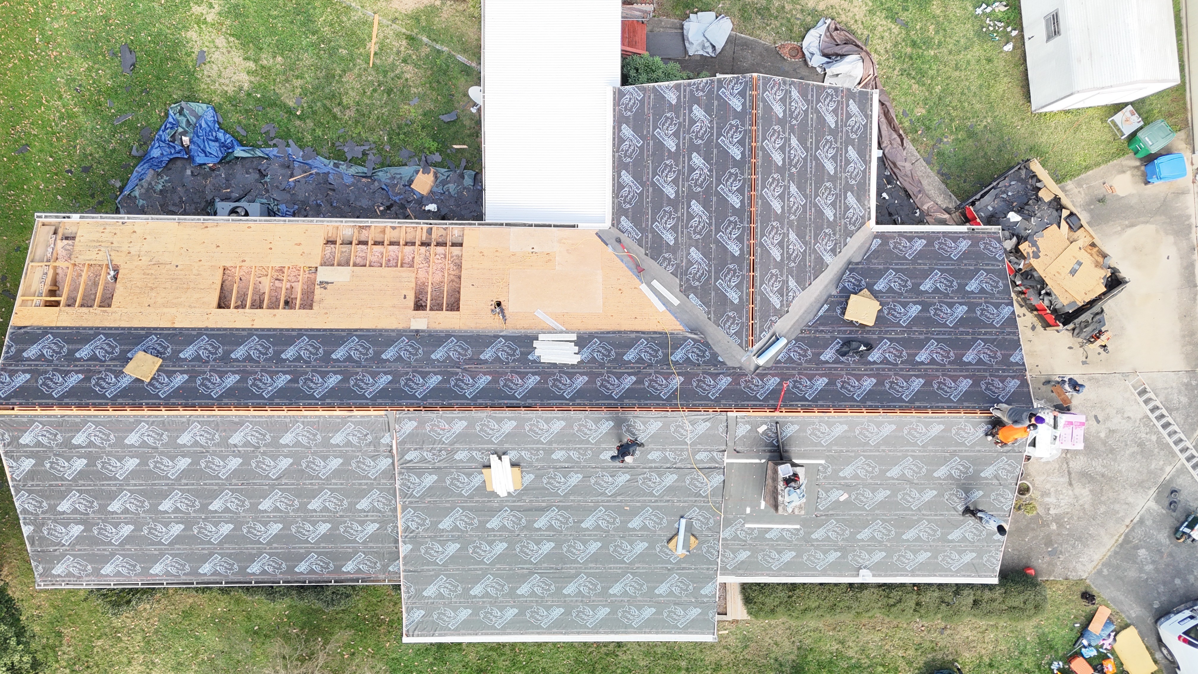 Roof tear-off and decking inspection in progress on a Monroe, NC home — Charlotte Ace Roofing crew working on the deck before installing new underlayment and shingles