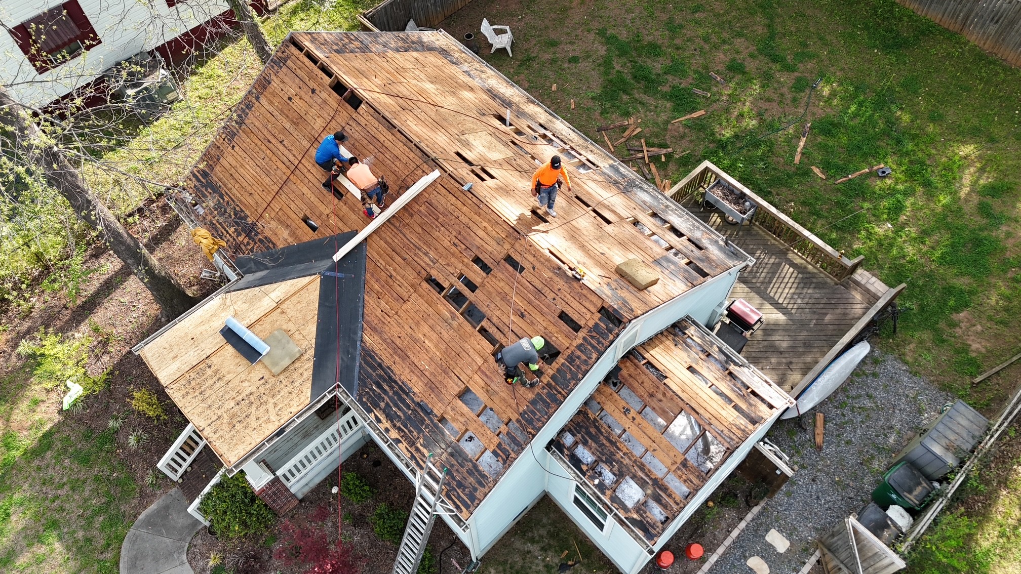Roof tear-off and decking inspection in progress on a Mooresville, NC home — Charlotte Ace Roofing crew working on the deck before installing new underlayment and shingles