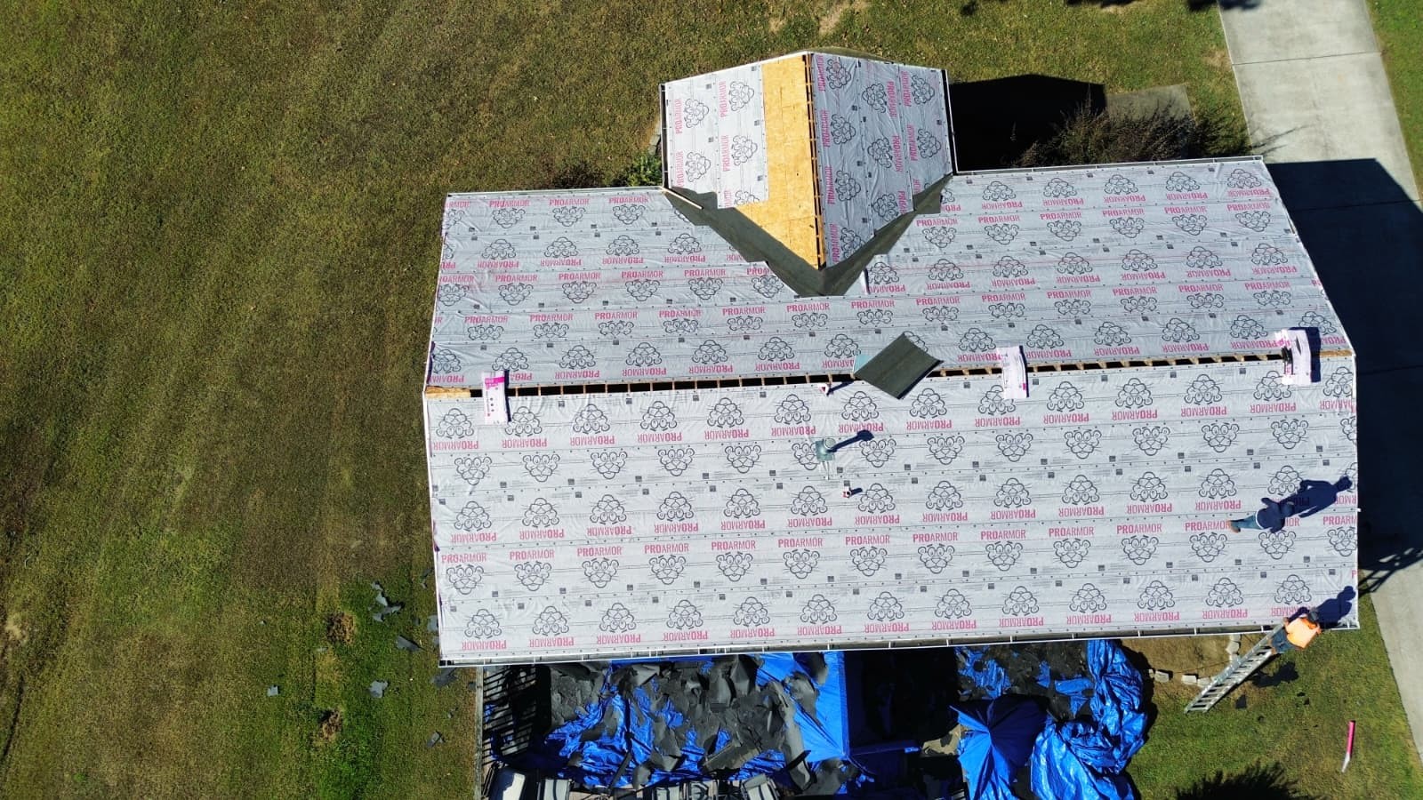 Roof installation in progress in Pineville, NC — synthetic underlayment fully installed before shingle layer by Charlotte Ace Roofing