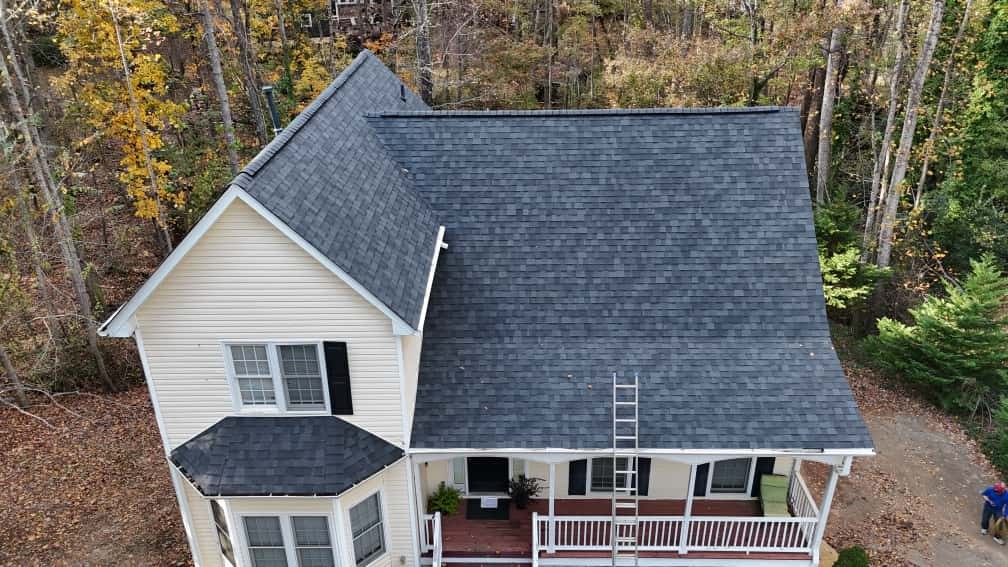 Completed architectural shingle roof replacement on a yellow two-story Victorian-style home in Pineville, NC — Charlotte Ace Roofing